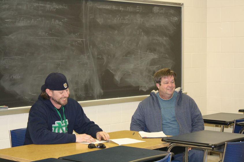 Student Christopher Brennan, left, interviews small business owner John McCreary. 