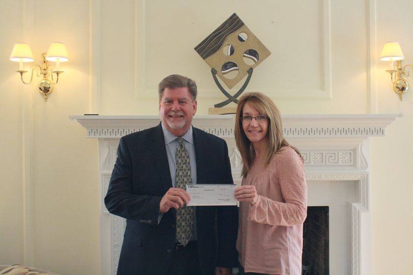 Chancellor M. Scott McBride accepts a check from Pam Walsh of CBT. 