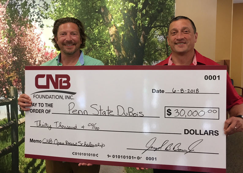 CNB President Joe Bower, right, presents a $30,000 check