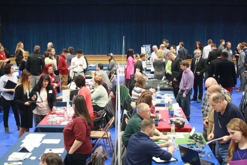 Jobseekers interact with employers during last year's career fair in the campus gymnasium.  