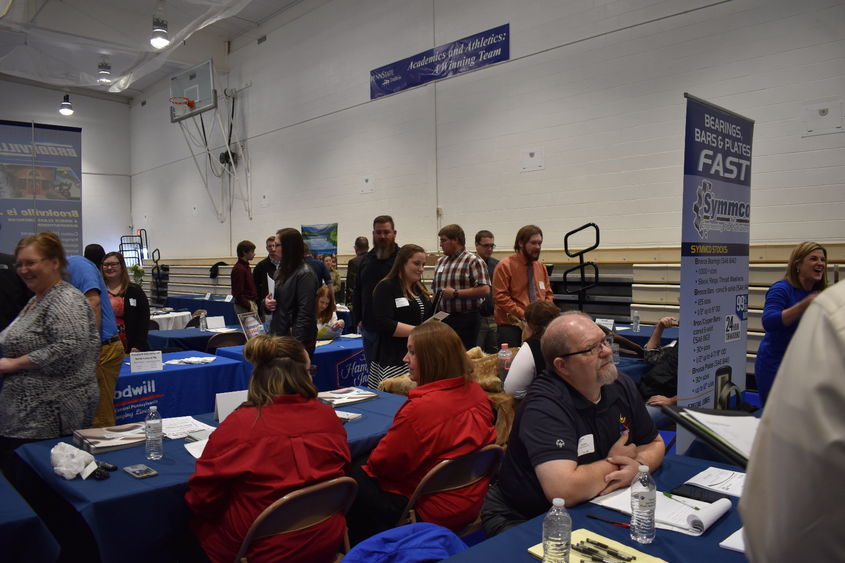Job seekers interact with employers during last year's career fair in the campus gymnasium.  