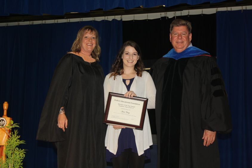 Jessica Clontz, center, receives the DEF Educator of the Year Award. 