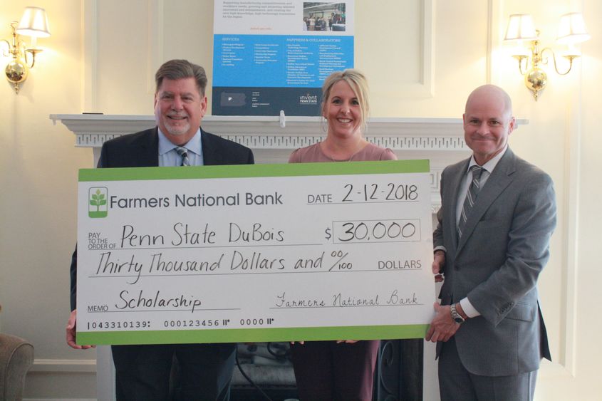 Chancellor M. Scott McBride accepts a check for the establishment of an Open Doors Scholarship from Farmers National Bank 