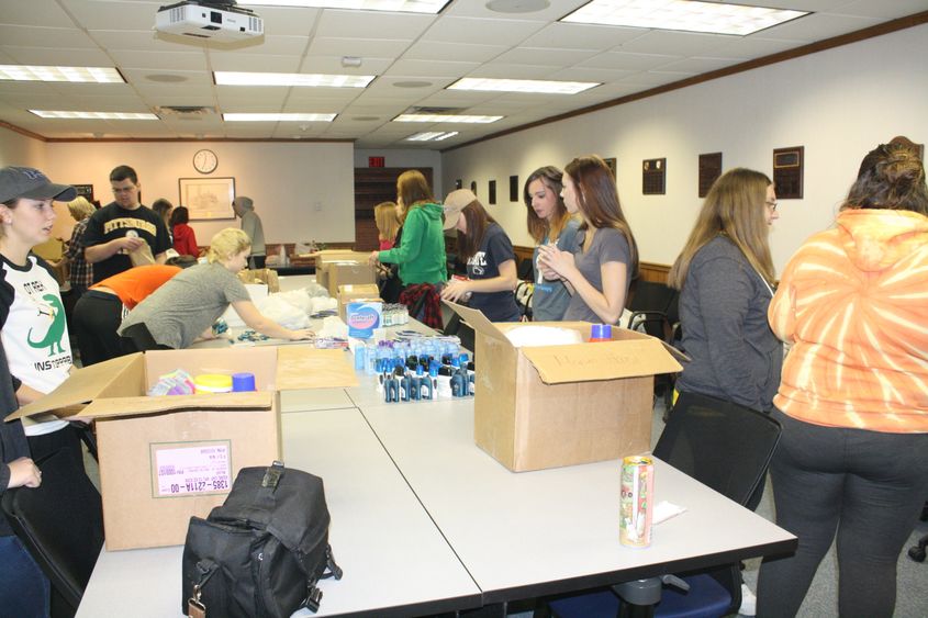 Students work to assemble Thanksgiving care packages. 
