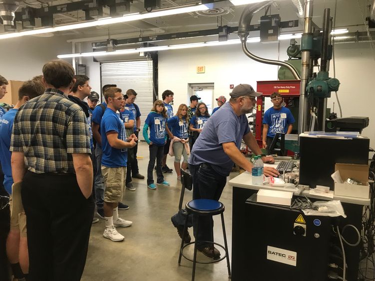 Students gathered in engineering labs for demonstrations of production processes.