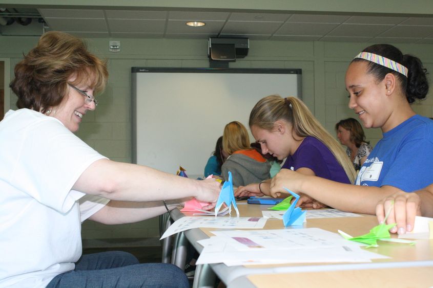 Chancellor Melanie Hatch works with students.