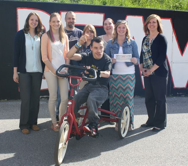 Students donate check to local boy.
