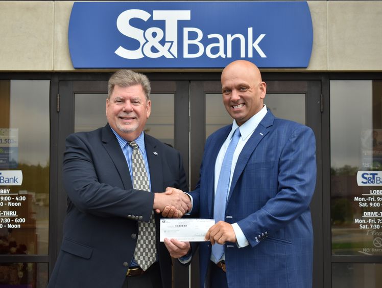 Chancellor M. Scott McBride accepts a check from S&T Bank’s Daniel Baronick.