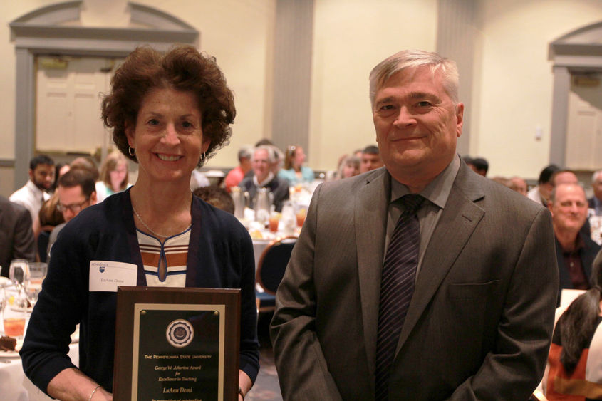 Luann Demi received her award from Penn State President Eric Barron. 