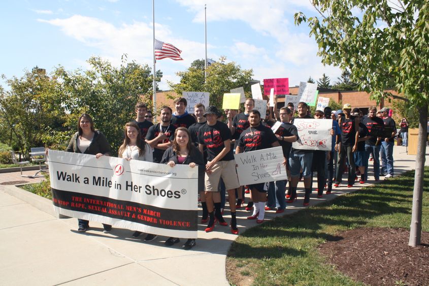 Men prepare to step off for Walk a Mile in Her Shoes. 