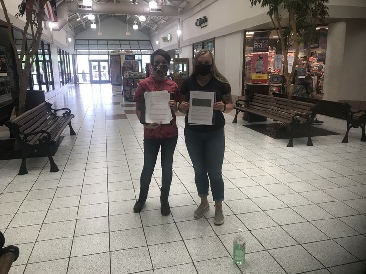Students, Tamara Seltzler, left, and Paige Pleta distributing surveys to members of the community.