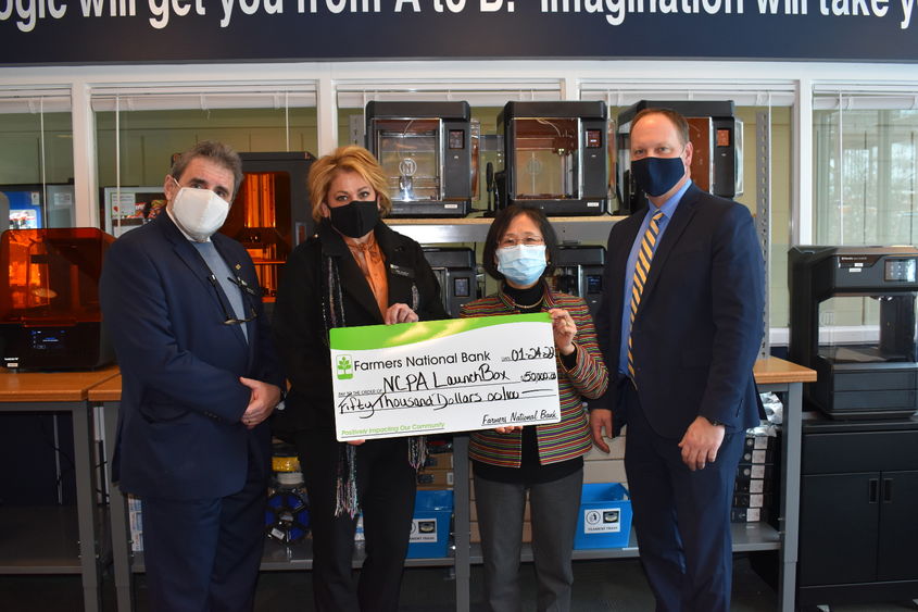 Farmer National Bank presents a $50,000 gift to NCPA LaunchBox. 