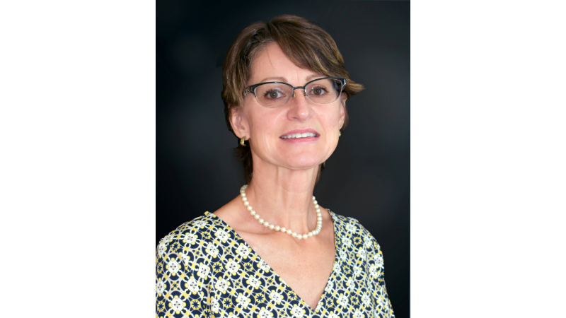 A woman wearing glasses and a necklace