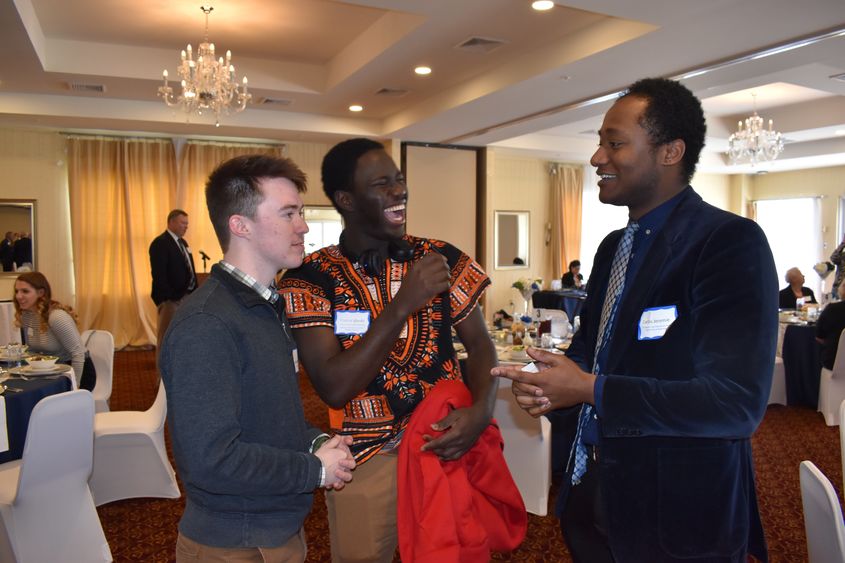 Carlos Jeremie, at right, talks with fellow scholarship recipients Stanley Igbudu, center, and Jacob Butterfuss, left.